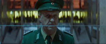 Movie still from “Atomic Blonde” (2017), directed by David Leitch – A person wearing a uniform; Close Up shot, Low angle