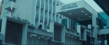 A person standing on the side of a building
