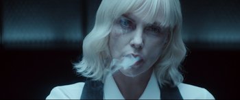 Movie still from “Atomic Blonde” (2017), directed by David Leitch – A woman smoking a cigarette while wearing a white wig; Close Up shot, Over the shoulder angle