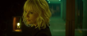 Movie still from “Atomic Blonde” (2017), directed by David Leitch – A woman with blonde hair is looking to her left; Close Up shot, Low angle