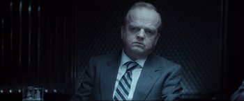 Movie still from “Atomic Blonde” (2017), directed by David Leitch – A man in a suit and striped tie looking angry; Close Up shot, Low angle
