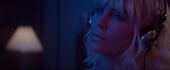 Movie still from “Atomic Blonde” (2017), directed by David Leitch – A woman in a blue room with a phone; Close Up shot, Low angle