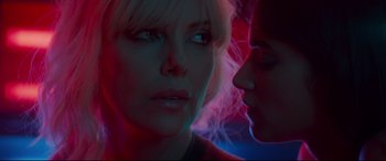 Movie still from “Atomic Blonde” (2017), directed by David Leitch – A woman with blonde hair and blue eyes looking at the camera; Close Up shot, Overhead angle