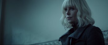 Movie still from “Atomic Blonde” (2017), directed by David Leitch – A woman with blonde hair and blue eyes; Close Up shot, Low angle