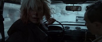 Movie still from “Atomic Blonde” (2017), directed by David Leitch – A woman in the driver's seat of a car in the snow; Close Up shot, Over the shoulder angle