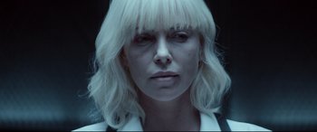 Movie still from “Atomic Blonde” (2017), directed by David Leitch – A person wearing a white wig; Close Up shot, Over the shoulder angle
