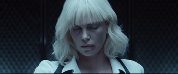 Movie still from “Atomic Blonde” (2017), directed by David Leitch – A person wearing a white wig; Close Up shot, Over the shoulder angle