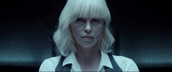 Movie still from “Atomic Blonde” (2017), directed by David Leitch – A person wearing a shirt and tie; Close Up shot, Over the shoulder angle