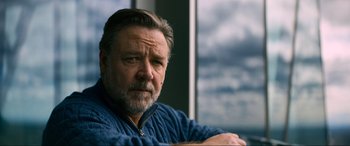 Movie still from “Poker Face” (2022), directed by Russell Crowe – A person sitting in front of a window; Close Up shot, Low angle
