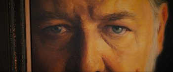 Movie still from “Poker Face” (2022), directed by Russell Crowe – An oil painting of a man's face with blue eyes; Extreme Close Up shot, Overhead angle