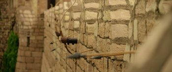 Movie still from “Ponniyin Selvan: Part Two” (2023), directed by Mani Ratnam – Arrows that are hanging on a wall; Extreme Close Up shot, Over the shoulder angle