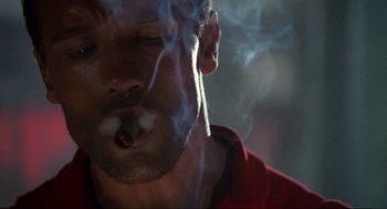 Movie still from “Predator” (1987), directed by John McTiernan – A person smoking a cigarette; Close Up shot, Low angle