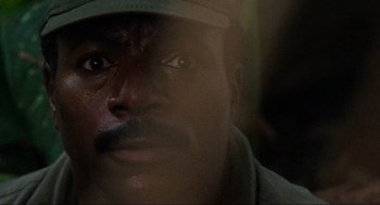 Movie still from “Predator” (1987), directed by John McTiernan – A man's face in the sunlight; Close Up shot, Low angle