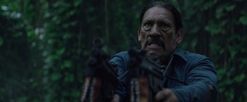 Movie still from “Predators” (2010), directed by Nimród Antal – A person holding a gun; Close Up shot, Low angle