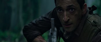 Movie still from “Predators” (2010), directed by Nimród Antal – A person holding a gun; Close Up shot, High angle