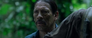 Movie still from “Predators” (2010), directed by Nimród Antal – An older man with a mustache and a beard; Close Up shot, Low angle