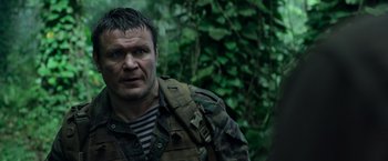 Movie still from “Predators” (2010), directed by Nimród Antal – A person wearing a jacket; Close Up shot, Low angle