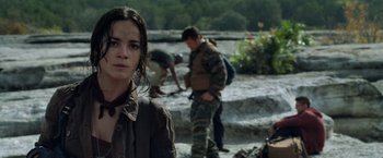 Movie still from “Predators” (2010), directed by Nimród Antal – A woman standing next to a man in a field; Close Up shot, Over the shoulder angle