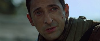 Movie still from “Predators” (2010), directed by Nimród Antal – A man's face with a spot on his cheek; Close Up shot, Over the shoulder angle