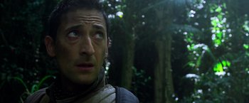 Movie still from “Predators” (2010), directed by Nimród Antal – A man's face in the woods; Close Up shot, Low angle