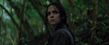 Movie still from “Predators” (2010), directed by Nimród Antal – A woman standing in the woods with wet hair; Close Up shot, Low angle