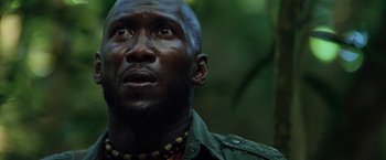 Movie still from “Predators” (2010), directed by Nimród Antal – A person looking up at the sky; Close Up shot, Low angle
