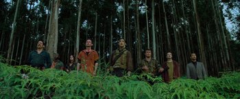 Movie still from “Predators” (2010), directed by Nimród Antal – A group of people standing in the forest; Wide shot, Low angle