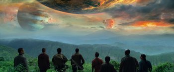 Movie still from “Predators” (2010), directed by Nimród Antal – A group of people standing on top of a hill; Extreme Wide shot, Low angle