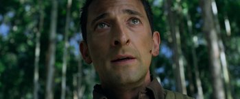 Movie still from “Predators” (2010), directed by Nimród Antal – A man's face with trees in the background; Close Up shot, Low angle
