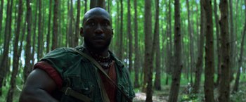 Movie still from “Predators” (2010), directed by Nimród Antal – A man standing in the middle of a forest; Close Up shot, Low angle