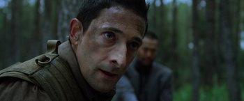 Movie still from “Predators” (2010), directed by Nimród Antal – A person wearing a jacket; Close Up shot, Low angle