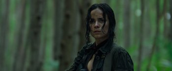 Movie still from “Predators” (2010), directed by Nimród Antal – A woman with wet hair and a black jacket; Close Up shot, Low angle