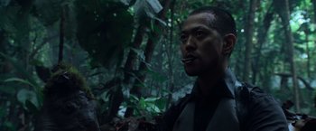 Movie still from “Predators” (2010), directed by Nimród Antal – A man is standing in the woods smoking a cigarette; Close Up shot, Low angle