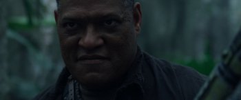Movie still from “Predators” (2010), directed by Nimród Antal – A man's face in the dark; Close Up shot, Low angle