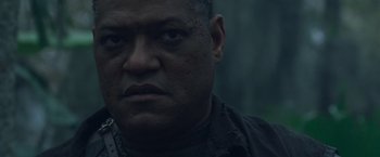 Movie still from “Predators” (2010), directed by Nimród Antal – A man's face in the dark; Close Up shot, Low angle