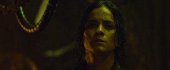Movie still from “Predators” (2010), directed by Nimród Antal – A person wearing a black shirt; Close Up shot, Low angle
