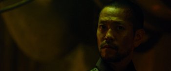 Movie still from “Predators” (2010), directed by Nimród Antal – A person with a beard; Close Up shot, Low angle