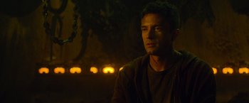 Movie still from “Predators” (2010), directed by Nimród Antal – A man is sitting in the dark at night; Close Up shot, Low angle