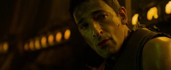 Movie still from “Predators” (2010), directed by Nimród Antal – A person looking down at the camera; Close Up shot, Over the shoulder angle