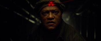 Movie still from “Predators” (2010), directed by Nimród Antal – A person wearing a hat; Close Up shot, Low angle