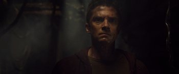 Movie still from “Predators” (2010), directed by Nimród Antal – A person in a dark room; Close Up shot, Low angle