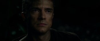 Movie still from “Predators” (2010), directed by Nimród Antal – A person looking at the camera; Close Up shot, High angle