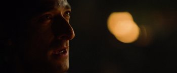 Movie still from “Predators” (2010), directed by Nimród Antal – A man's face in the dark; Extreme Close Up shot, Over the shoulder angle