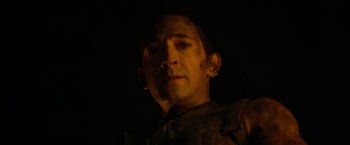 Movie still from “Predators” (2010), directed by Nimród Antal – A person wearing a military uniform; Close Up shot, Low angle