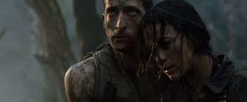 Movie still from “Predators” (2010), directed by Nimród Antal – A man and a woman are looking at the camera; Close Up shot, Low angle