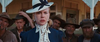 Movie still from “Australia” (2008), directed by Baz Luhrmann – A woman wearing a white hat and a polka dot tie; Close Up shot, Low angle