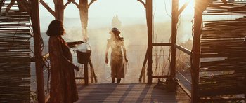 Movie still from “Australia” (2008), directed by Baz Luhrmann – A person walking on a wooden bridge in the sunlight; Wide shot, Low angle