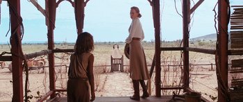 Movie still from “Australia” (2008), directed by Baz Luhrmann – A woman and a child are standing on a porch; Wide shot, Over the shoulder angle