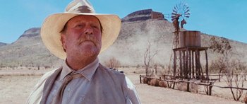 Movie still from “Australia” (2008), directed by Baz Luhrmann – An older man wearing a cowboy hat in the desert; Close Up shot, Low angle