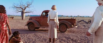 Movie still from “Australia” (2008), directed by Baz Luhrmann – A woman standing in front of an old red truck; Wide shot, Over the shoulder angle
